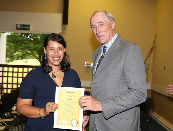 Danielle is presented with her Merit Certificate