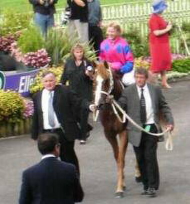 Owner-breeder John Powell, left, leads in Baldessarini & jockey Lisa Cropp after the Railway H. G1