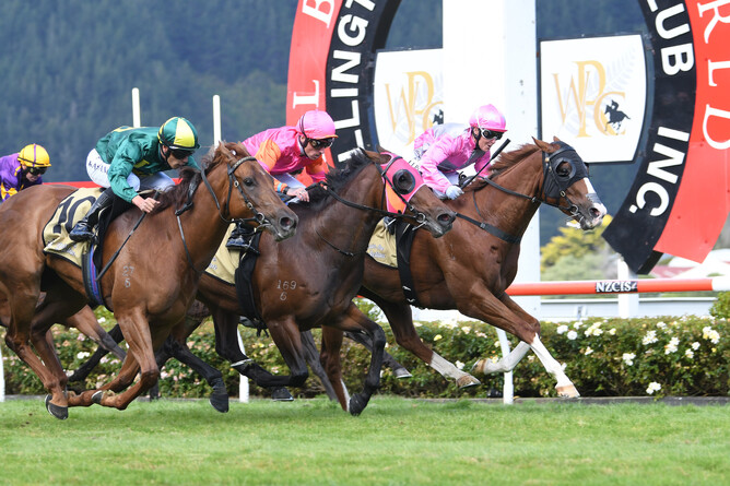 A beaming Lisa Allpress guides Grand Mayson (inner) to victory in the Listed Hardy Trade Supply Company Lightning Handicap (1200m). Photo Credit: Race Images – Peter Rubery