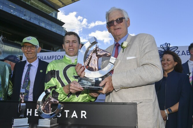 Trainer Jim Wallace and jockey Damian Lane pose with their Australian Oaks trophies - Photo: bradleyphotos.com.au