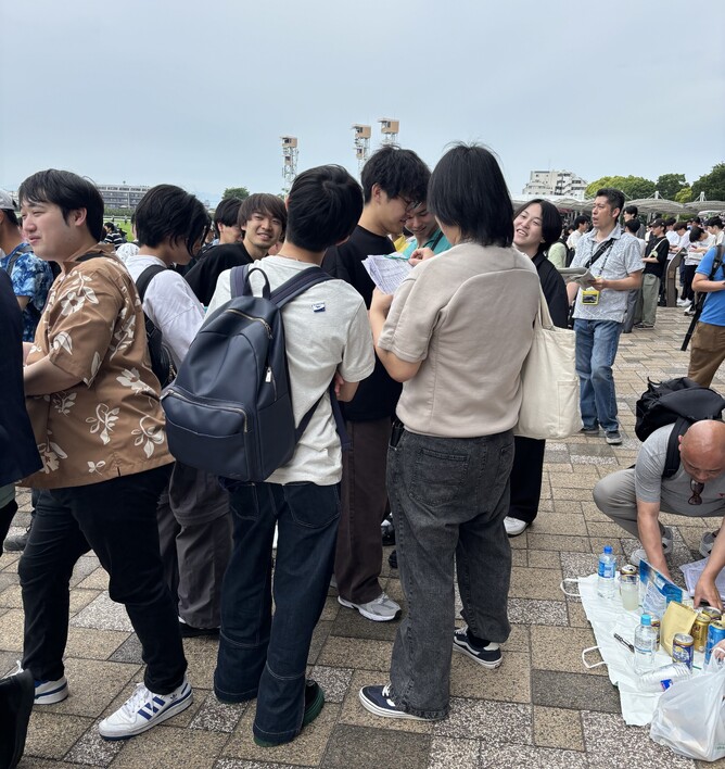 Groups of youngsters, studying the form and enjoying their day out.