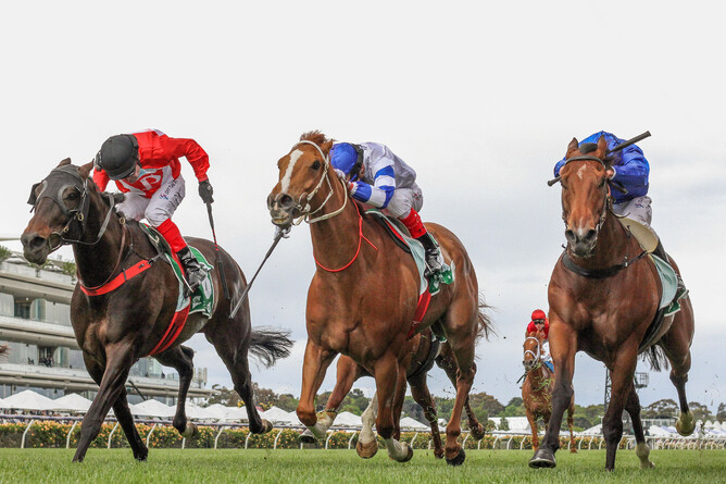 Justacanta (outer) and rider Dean Yendall time their run to perfection to win the Gr.2 Linlithgow Stakes (1200m) at Flemington Photo Credit: Bruno Cannatelli