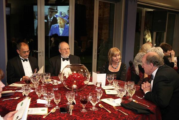 An image of Her Majesty The Queen at Royal Ascot is reflected in the window behind His Excellency, the Governor General, Lt. Gen. the Rt. Hon. Sir Jerry Mateparae (left), NZTBA President Peter Francis, Her Excellency Lady Janine Mateparae and former NZTBA President John Aubrey. - PHOTO: Trish Dunell