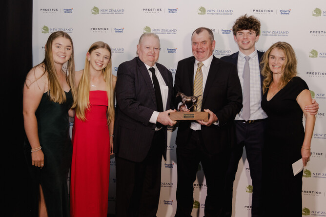 Warwick Jeffries, flanked by his family, receives the New Zealand Small Breeder of the Year Award from Novara Park’s Don Edwards - Photo: Christine Dawkins