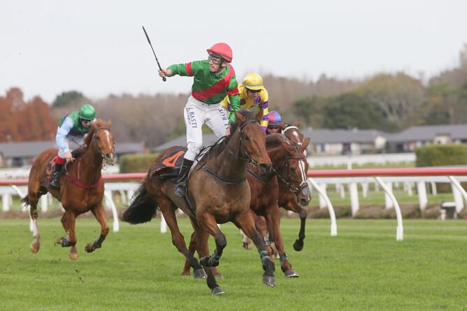 Shaun Fannin gives a winning salute as he crosses the line aboard Mesmerize at Te Rapa Photo Credit: Trish Dunell