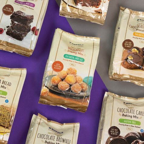 Packaging design of Bakels Gold Label Baking mixes on display against a grey and purple backdrop.