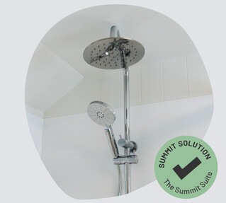 A close up of a chrome double shower head unit. 
