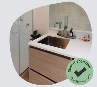 A stainless steel sink in a vanity unity.