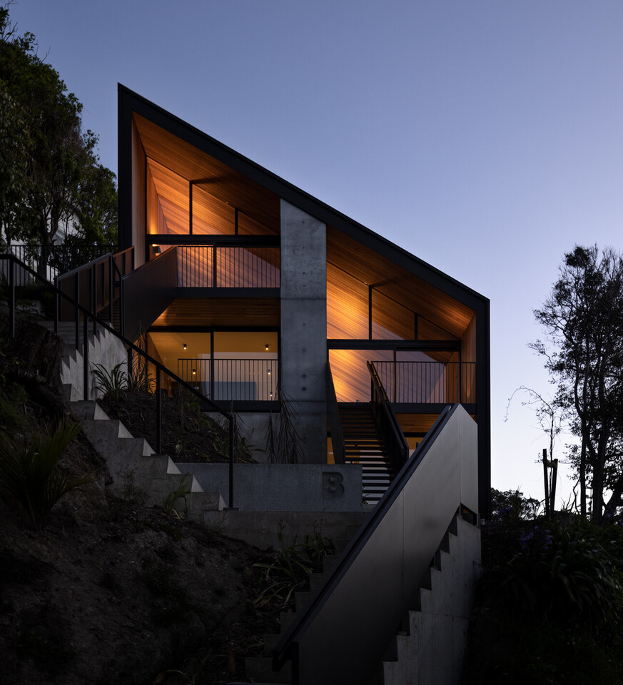 An architectural home at night.