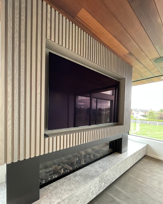 Ardent Building Developments. Hamilton, Waikato. NZ. Image of new home build interior. Wooden feature wall with encased television and fireplace.