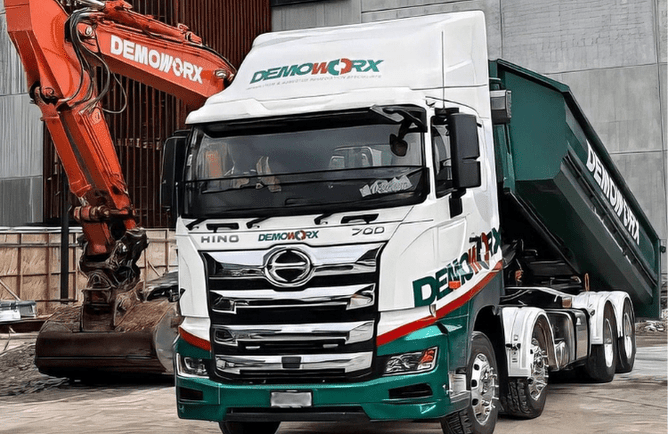 Demoworx demolition truck and excavator on site