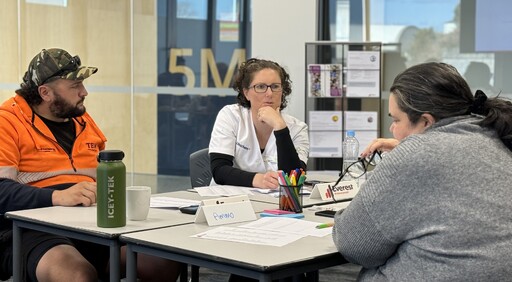 Three adults in conversation