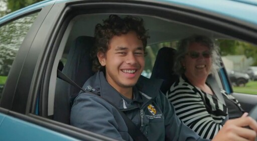 Two people smiling in a car