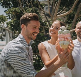 A bride and groom enjoying a Kūaotunu killer ice cream from the Kūaotunu Store