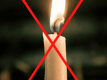 A burning candle with a red cross through it