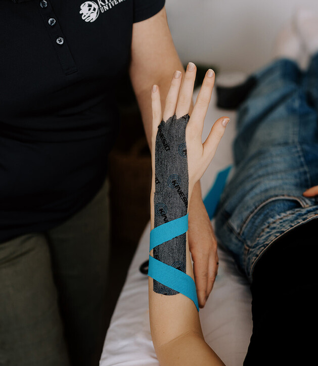 Image of women having her arm taped with Kinesio taping by Heather Lever at Vital Body Therapy. Cambridge & Morrinsville. New Zealand.