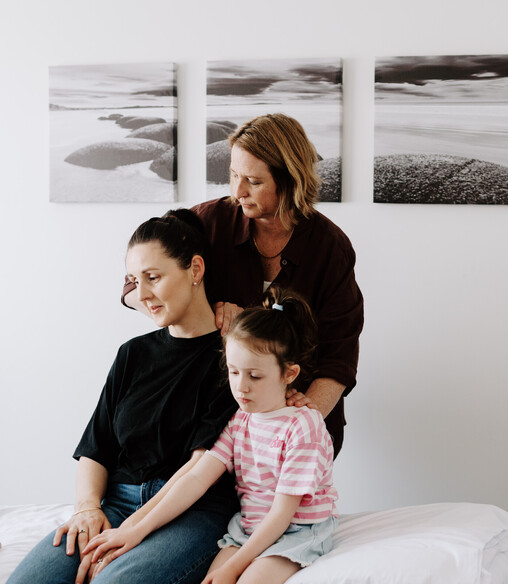 Image of Heather from Vital Body Therapy treating a mum and her young child with Craniosacral Therapy. Cambridge clinic location, Waikato. New Zealand.