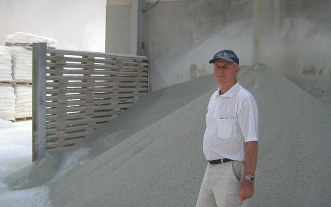 Chemical Engineer Frank King in 2006 at Fertco's Mt Maunganui factory with a pile of dicalcic phosphate behind him.