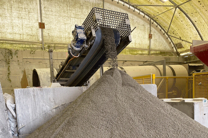 DCP granules coming off a conveyor belt.