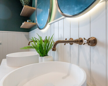 Close up image of copper taps in newly deep sage & white renovated heritage bathroom. Renovated by local Te Awamutu residential builders, Whitechurch Construction.