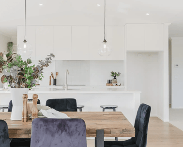 Image of light filled dining area and white washed modern kitchen in Collinson Street, Pirongia new home, by Waikato residential builders Whitechurch Construction Limited.