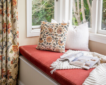 Close up image of window seat and floral print cushion and curtains in newly renovated master bedroom. Renovated by local Te Awamutu residential builders, Whitechurch Construction.