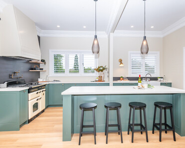 Image of newly renovated heritage kitchen in deep sage & white. Renovated by local Te Awamutu residential builders, Whitechurch Construction.