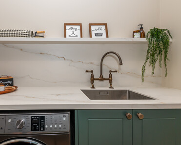 Image of newly renovated heritage laundry room in deep sage & white. Renovated by local Te Awamutu residential builders, Whitechurch Construction.