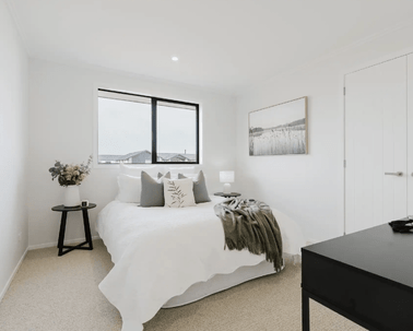 Image of natural light filled bedroom and soft grey styling in Collinson Street, Pirongia new home, by Waikato residential builders Whitechurch Construction Limited.