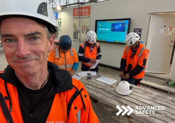 Advanced Safety smiling construction worker wearing high vis vests and hard hats. Construction team meeting