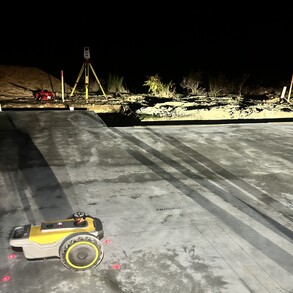 PLS siteprint at work at night on a concrete slab.