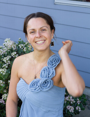 Girl smiles for photo in beautiful violet coloured bridesmaid dress