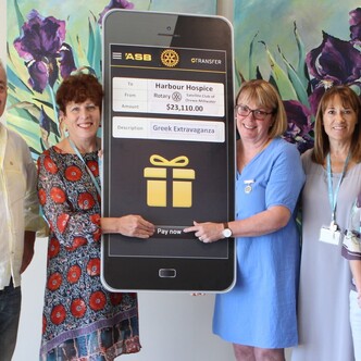 A giant cheque being presented to Harbour Hospice