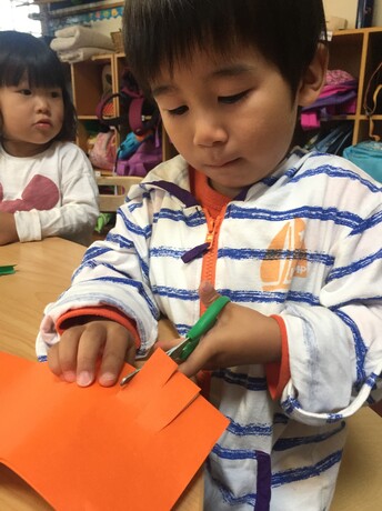 Holding scissors is a precursor to holding a pencil